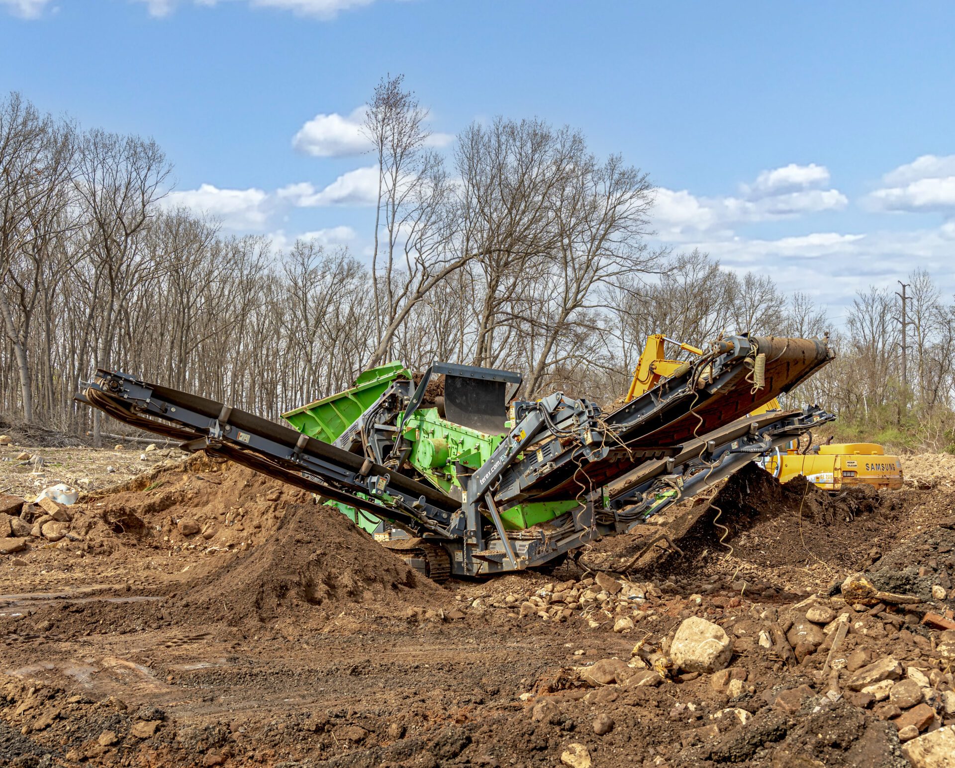 topsoilmulch Screening machine processing topsoil at a Bristol, CT landscape supply yard — creating clean, high-quality screened topsoil for delivery and installation.